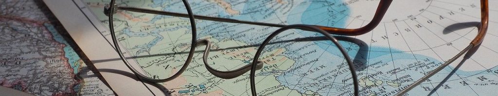 Pair of glasses on a world map, indicating the importance of knowing practical information such as location.